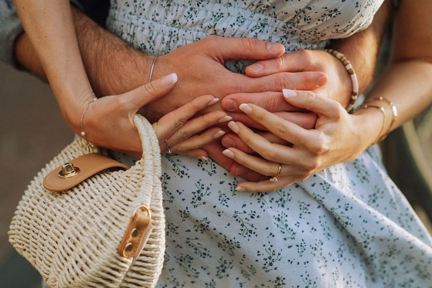 Close-up of lovers’ hands embracing after the secret proposal moment on an Amsterdam bridge