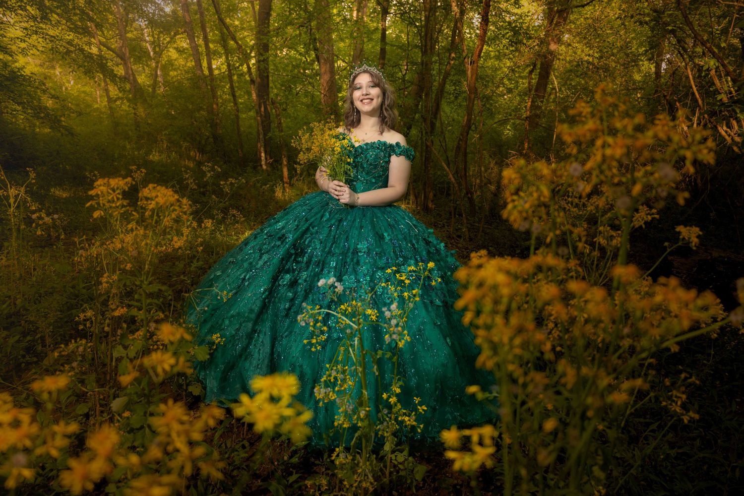 Flowing green ball gown surrounded by golden autumn foliage.