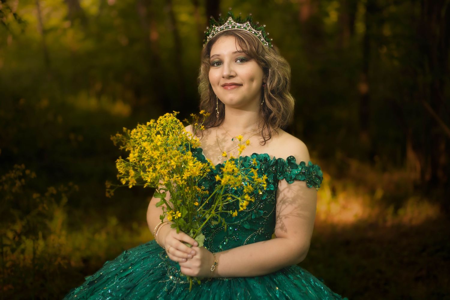 Enchanting forest portrait in emerald dress with floral crown.