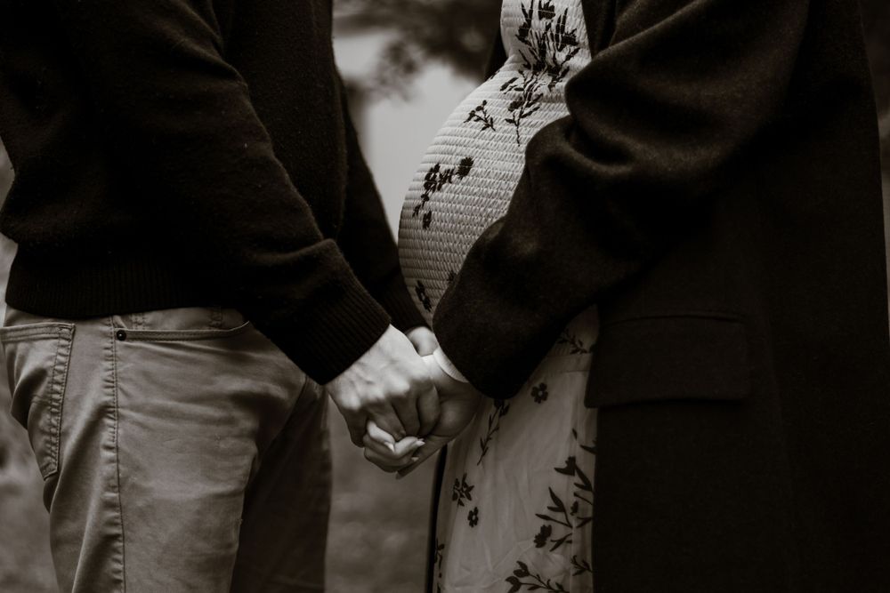 Intimate black and white portrait of a couple sharing a tender moment.