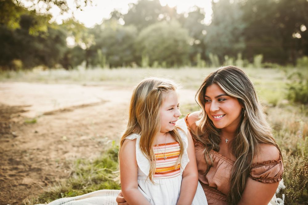 A series of warm sunset photos showing tender family moments in a golden field during a lifestyle photography session.