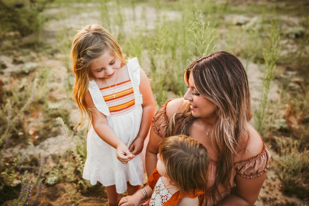 A series of outdoor family portraits showing tender moments between parent and child in a natural wooded setting.