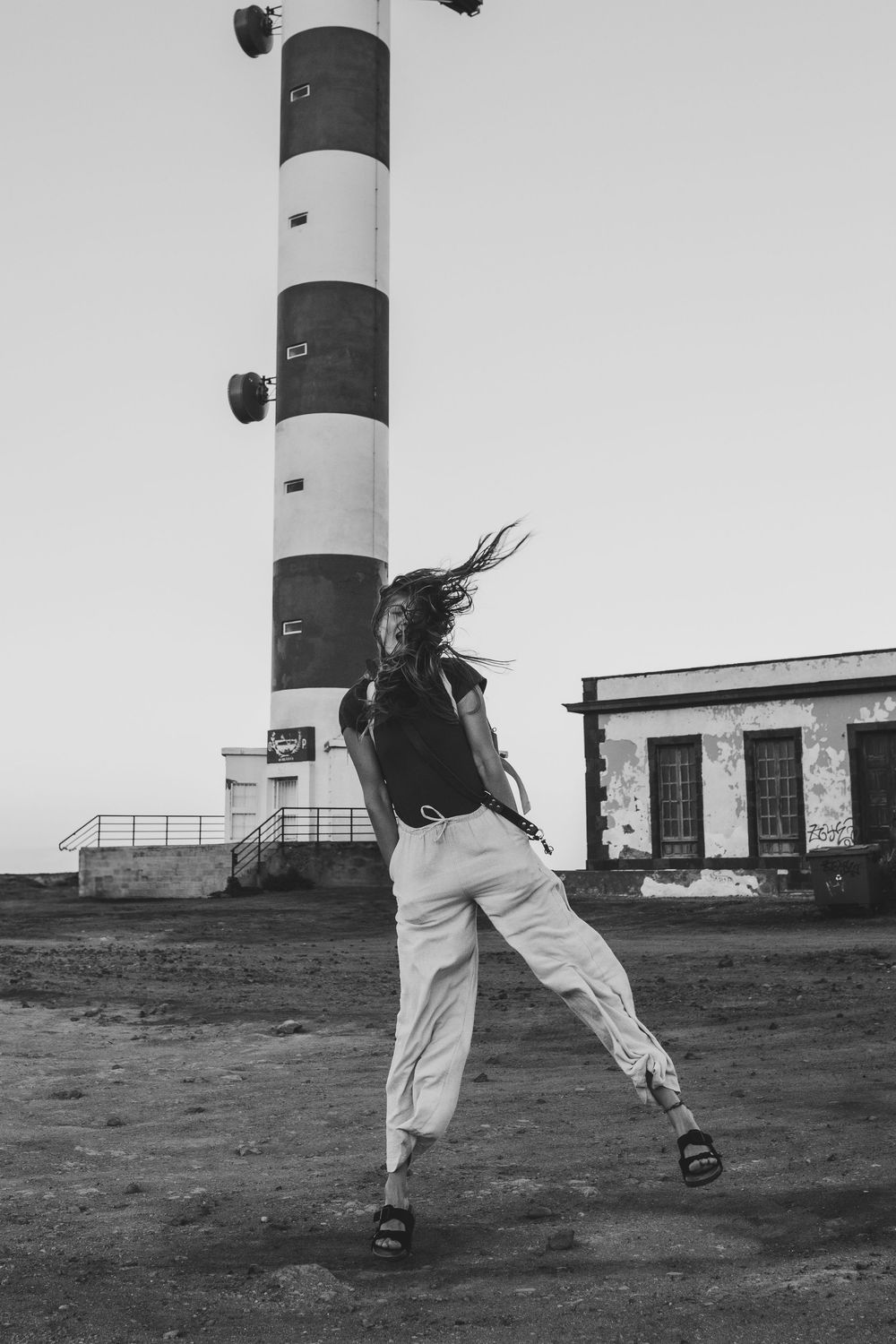 Paula embracing a windy day in Tenerife, smiling and enjoying the fresh air.