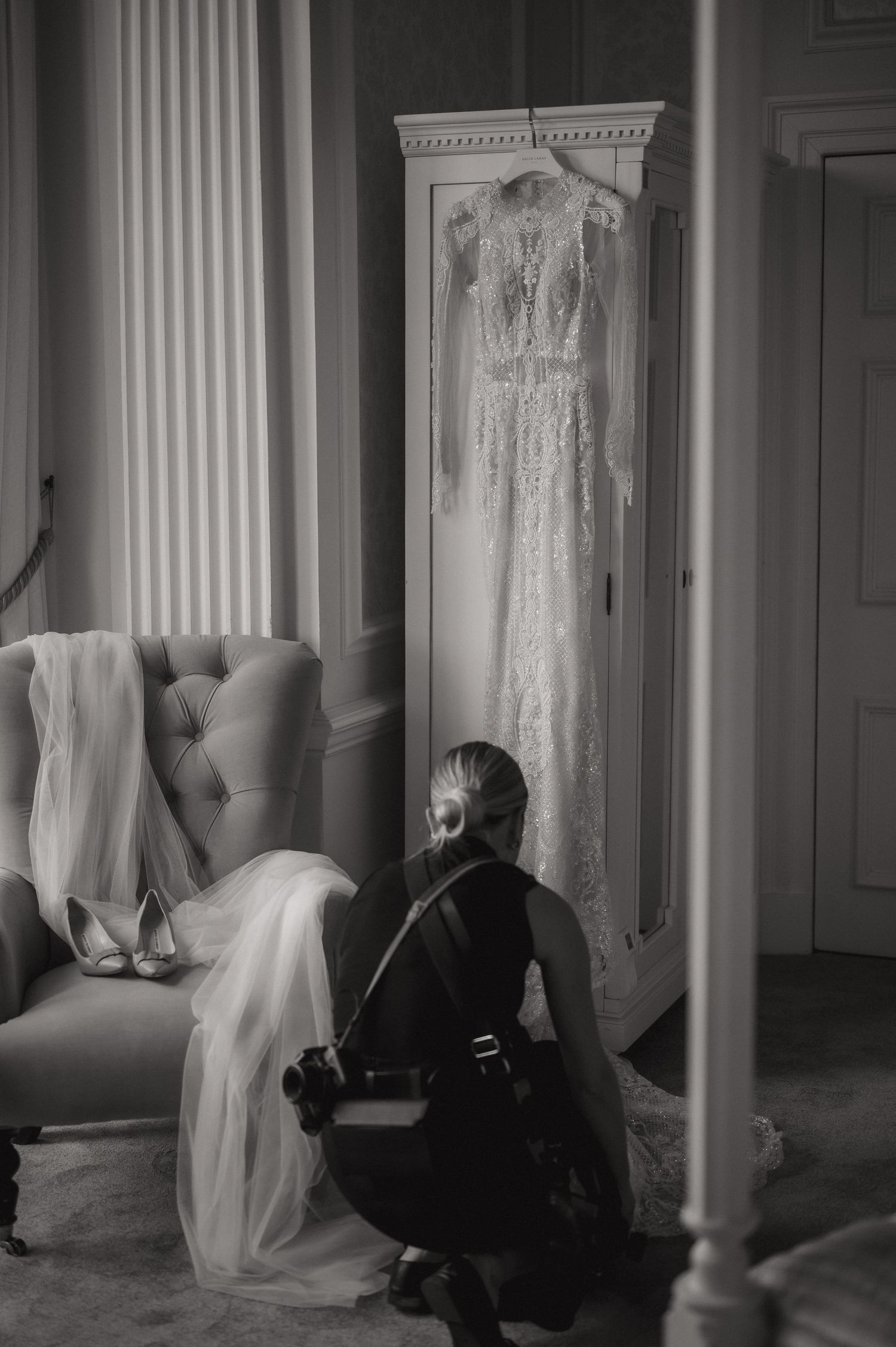 Black and white series of four haunting images showing ghostly white dresses hanging between classical columns in a dark room.