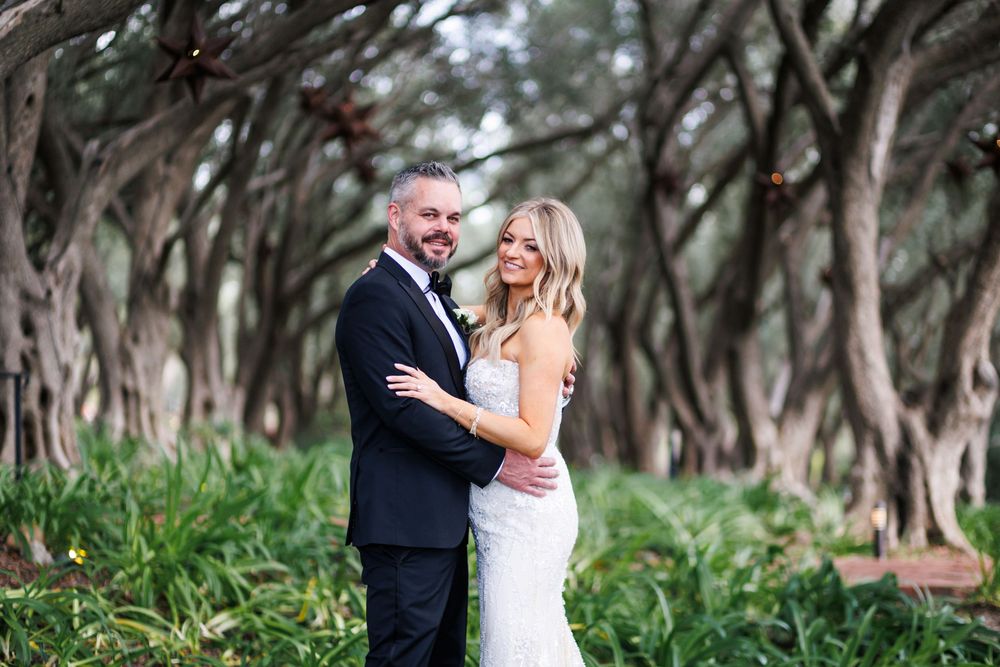 A romantic outdoor wedding photoshoot among trees and natural scenery.