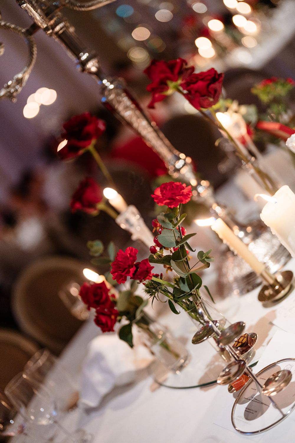 Elegant table setting with white candles and red roses by Tie the Knot Weddings at Adare Manor