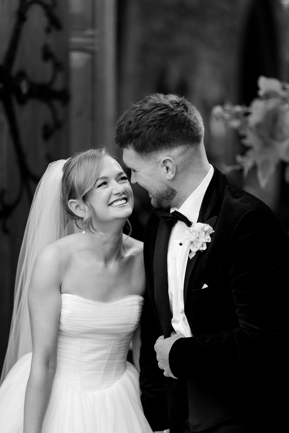 A bride and groom share romantic moments in a black and white photo in Adare Manor Wedding by Sarah Kate Photography