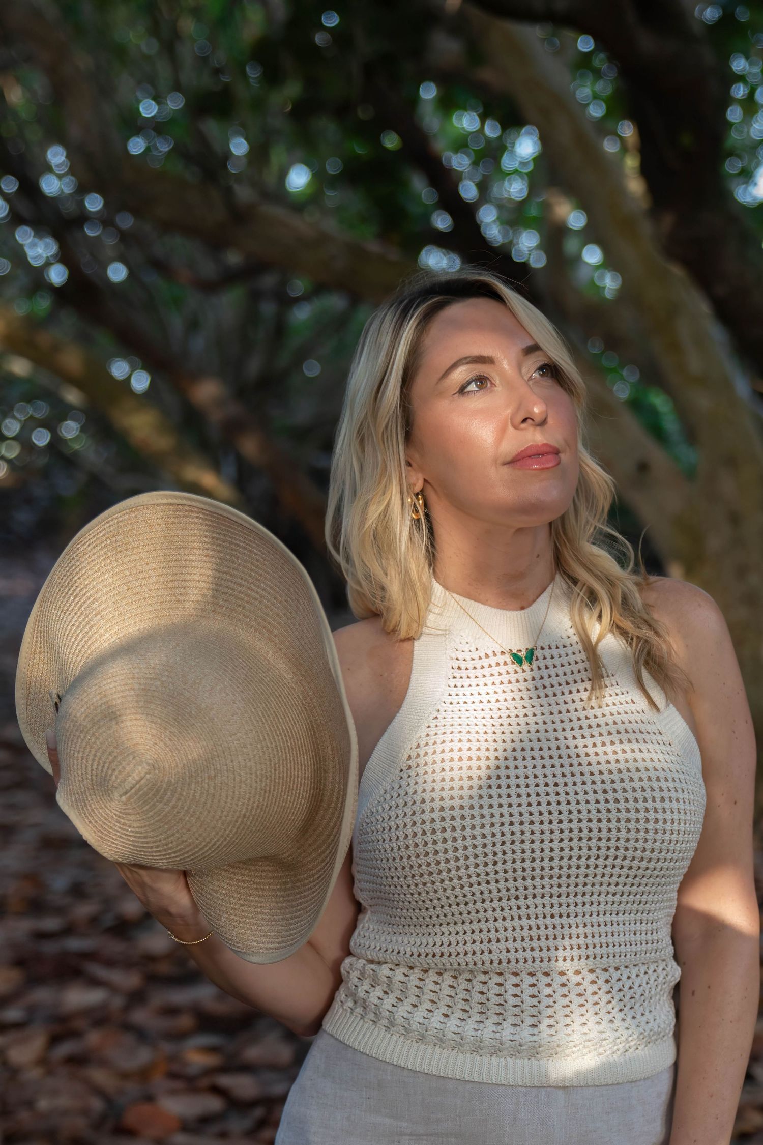 Client posing in the dappled sunlight under the trees of coral cove in tequesta florida