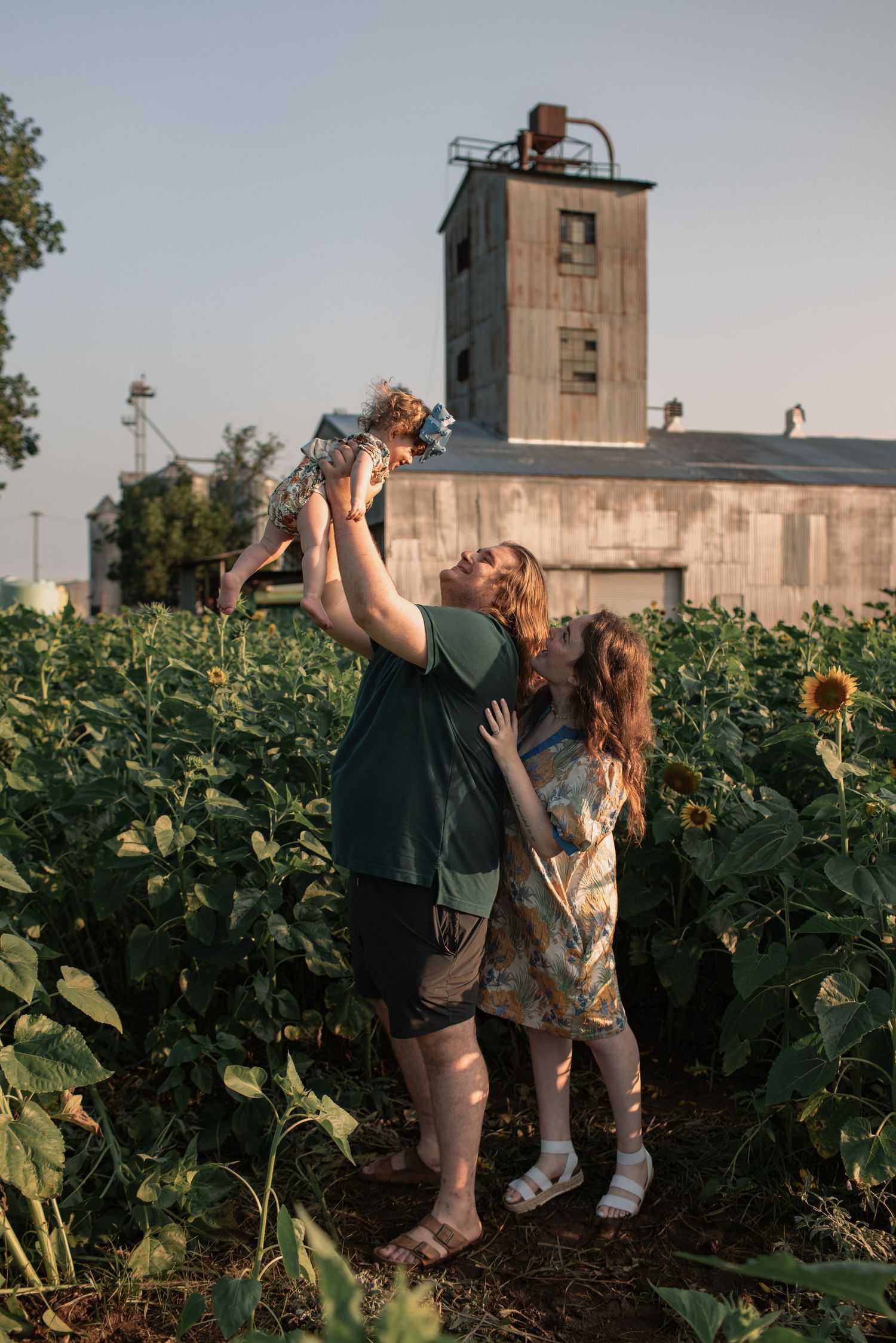 A couple in matching plaid and green outfits share tender moments in a series of outdoor photos.