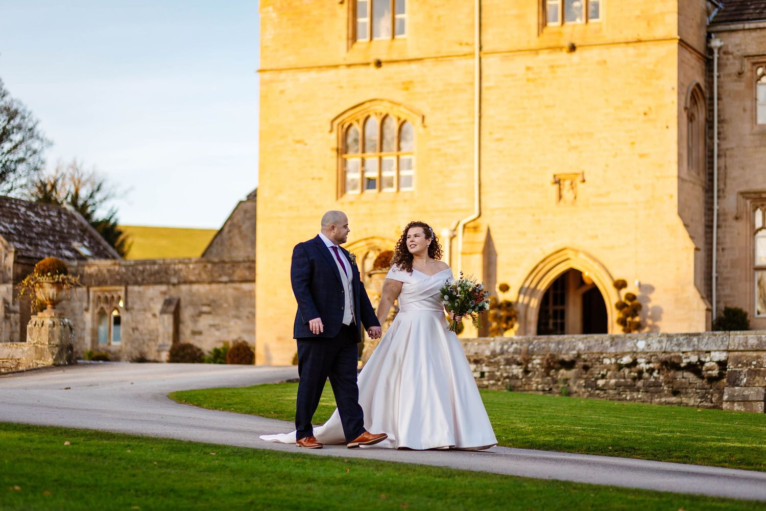 Relaxed Wedding moment of bride & groom walking  at Wennington Hall by Lynette Matthews Photography ,Lancashire wedding photographer.