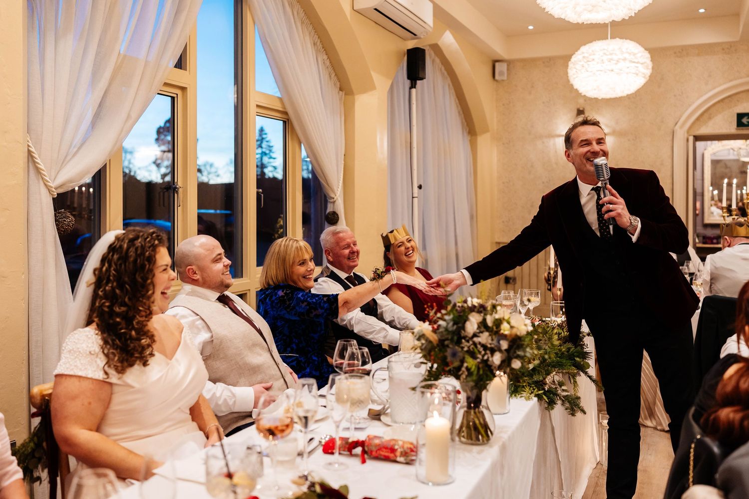 Wedding guests enjoy a celebratory reception dinner in an elegant room at wennington hall, Lancaster hosted by Howard Wing,