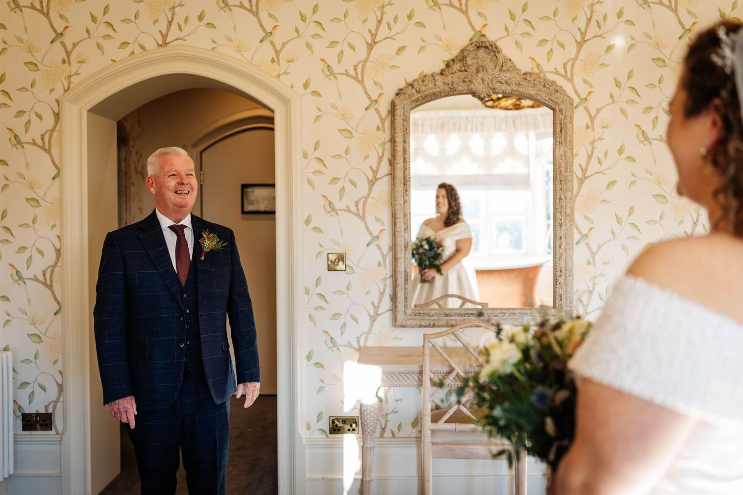 A bride during her first look with her dad at Wennington Hall captured by Lancashire Wedding Photographer, Lynette Matthews Photography