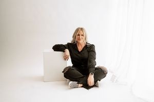 Person in black outfit poses gracefully across four connected artistic portrait photographs.