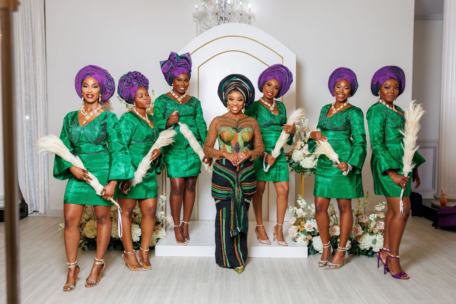 Wedding party group photo with matching emerald green outfits.