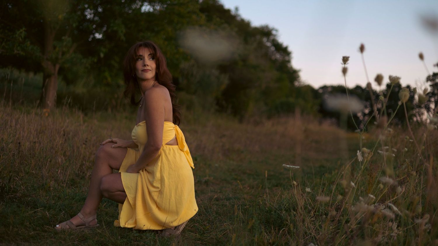 A series of outdoor lifestyle photographs showing a person in a yellow dress sitting in natural settings at sunset.