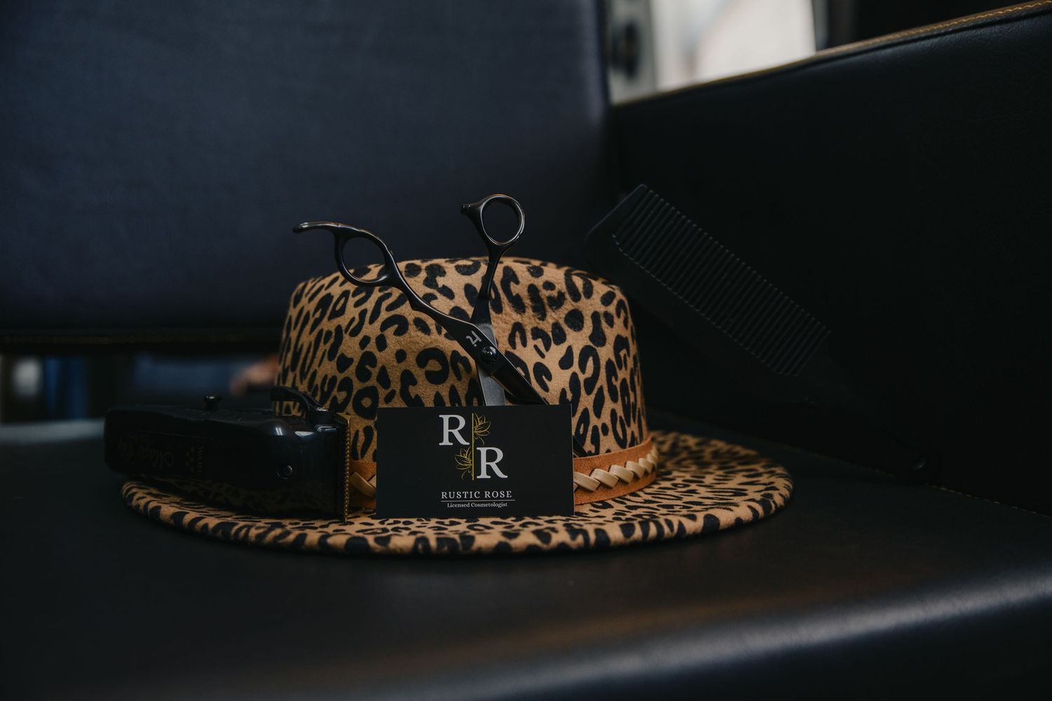 A collection of leopard print hats and accessories displayed in a retail setting against a dark background.