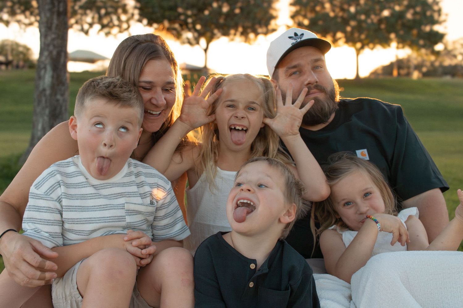 Outdoor family photo session in Surprise, AZ, capturing a happy family in a natural desert landscape.