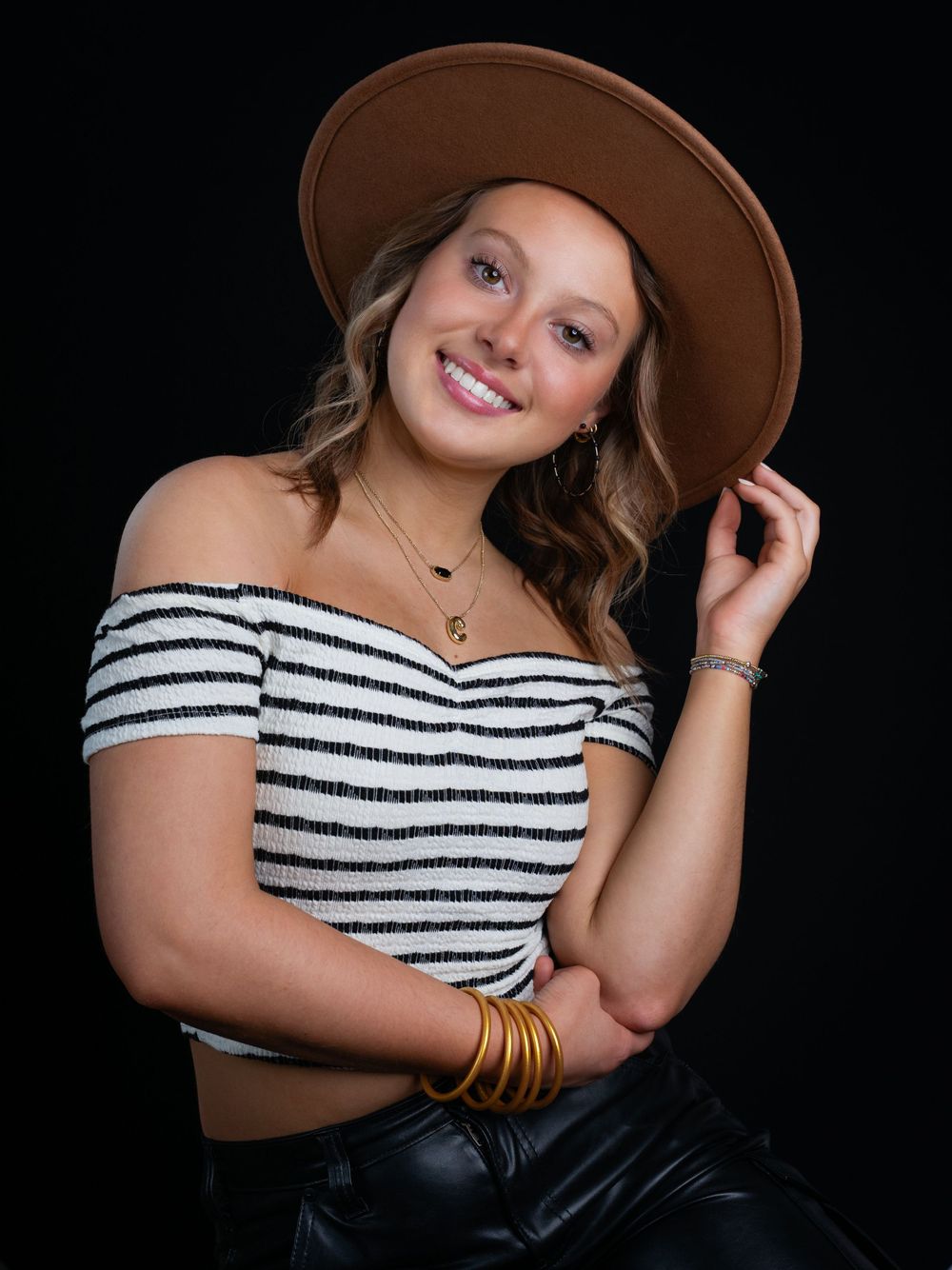 Photo of high school senior girl in black and white cropped top by senior portrait photographer in Dandridge studio in East Tennessee.