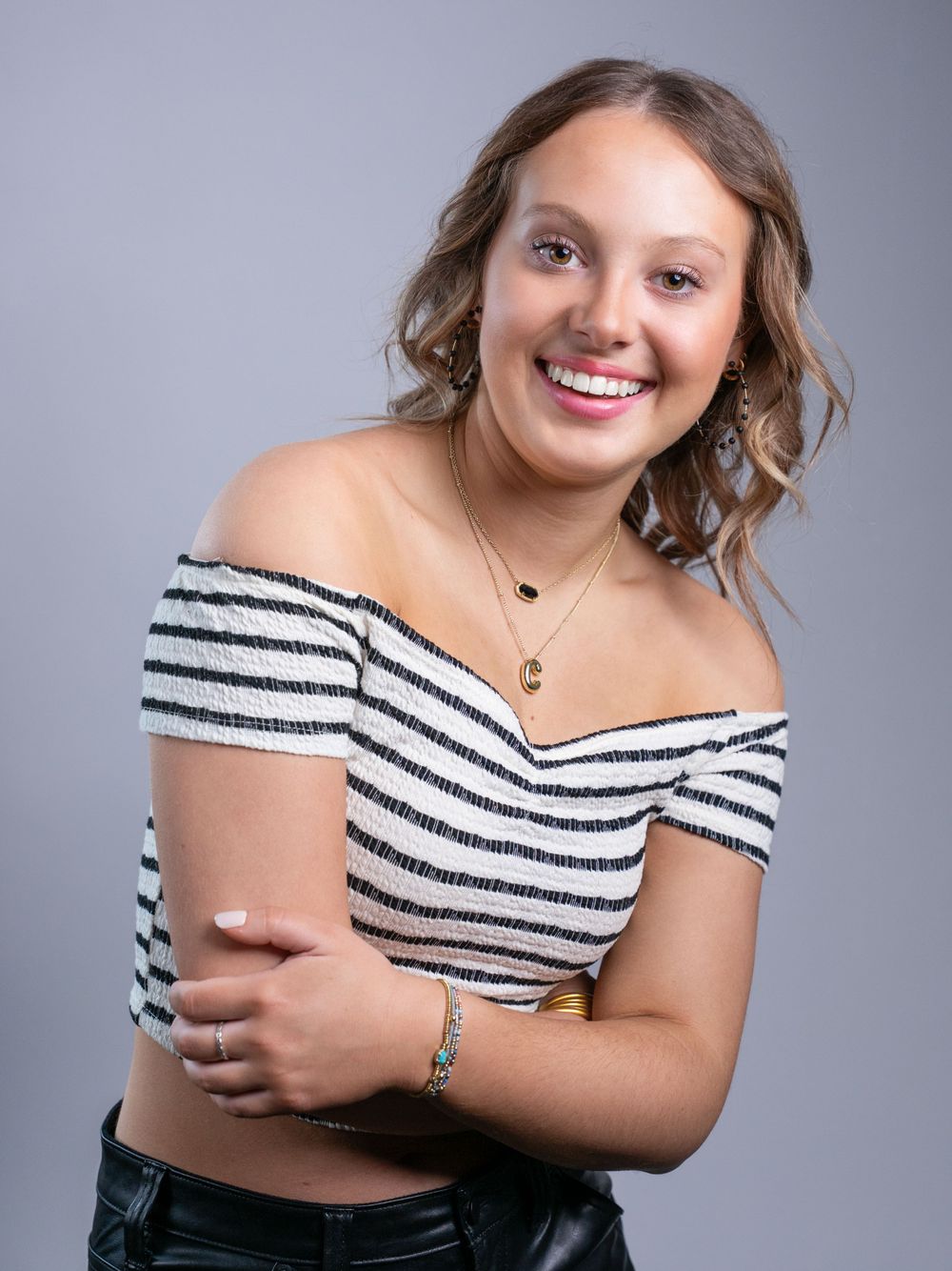 Photo of high school senior girl in black and white cropped top by senior portrait photographer in Dandridge studio in East Tennessee.