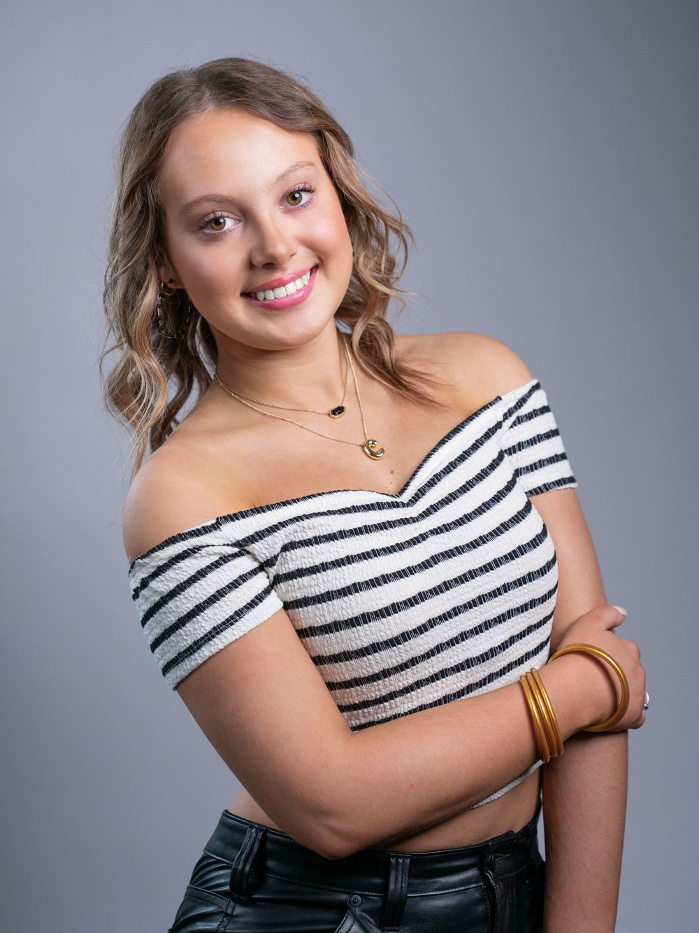 Photo of high school senior girl in black and white cropped top by senior portrait photographer in Dandridge studio in East Tennessee.