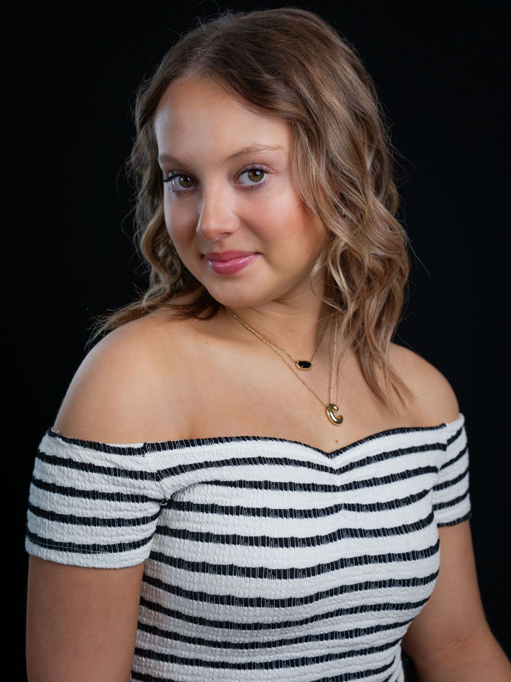 Photo of high school senior girl in black and white cropped top by senior portrait photographer in Dandridge studio in East Tennessee.