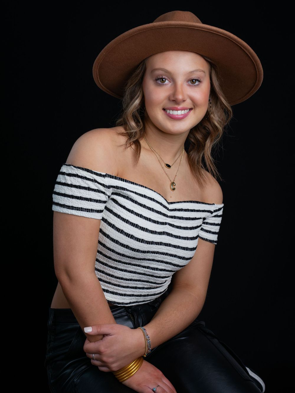 Photo of high school senior girl in black and white cropped top by senior portrait photographer in Dandridge studio in East Tennessee.