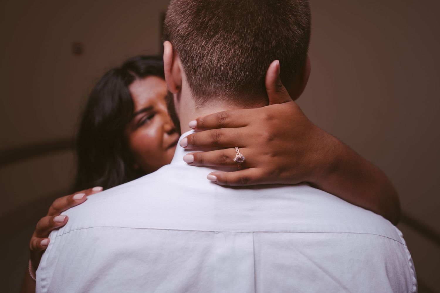 Close-up shot of two people in an intimate embrace.