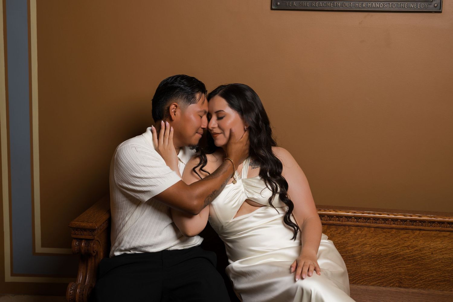 A couple in white and black attire share a romantic dance moment.