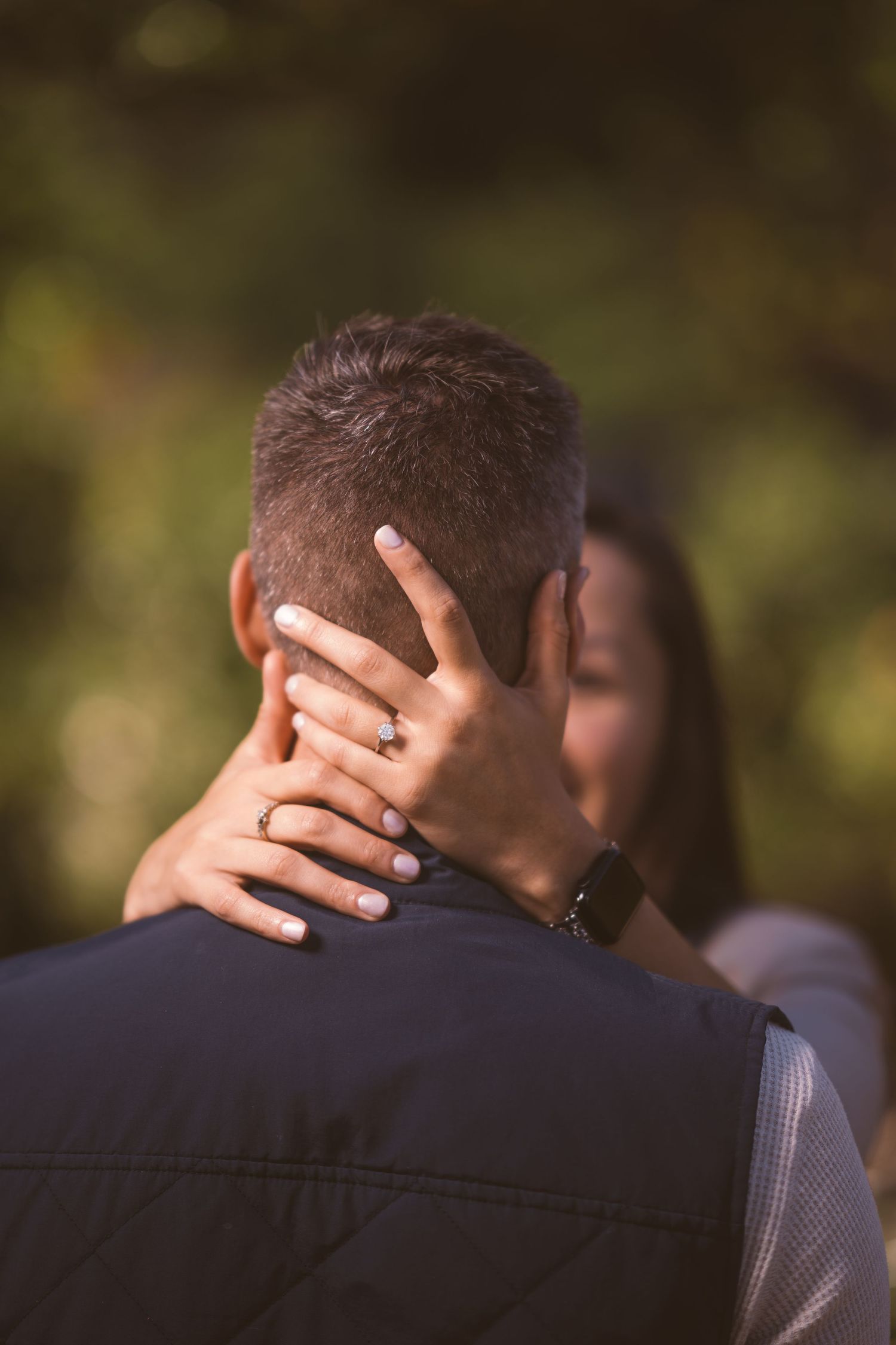 Close-up shot focusing on intimate embrace against autumn background.