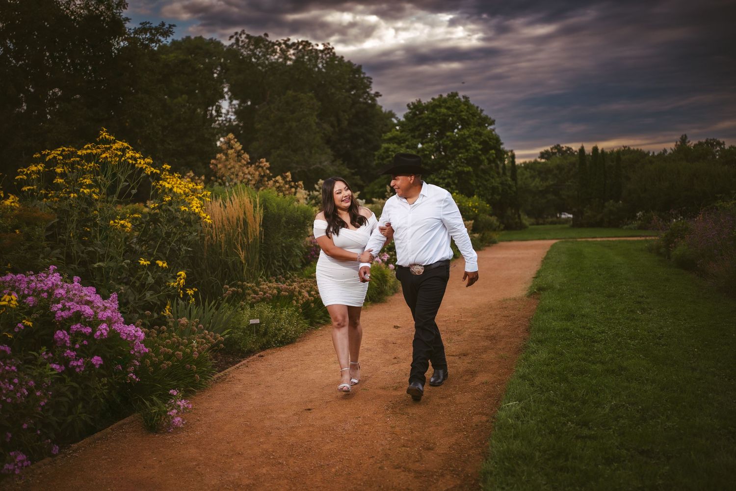 A romantic garden photoshoot with dramatic storm clouds and colorful flowers.