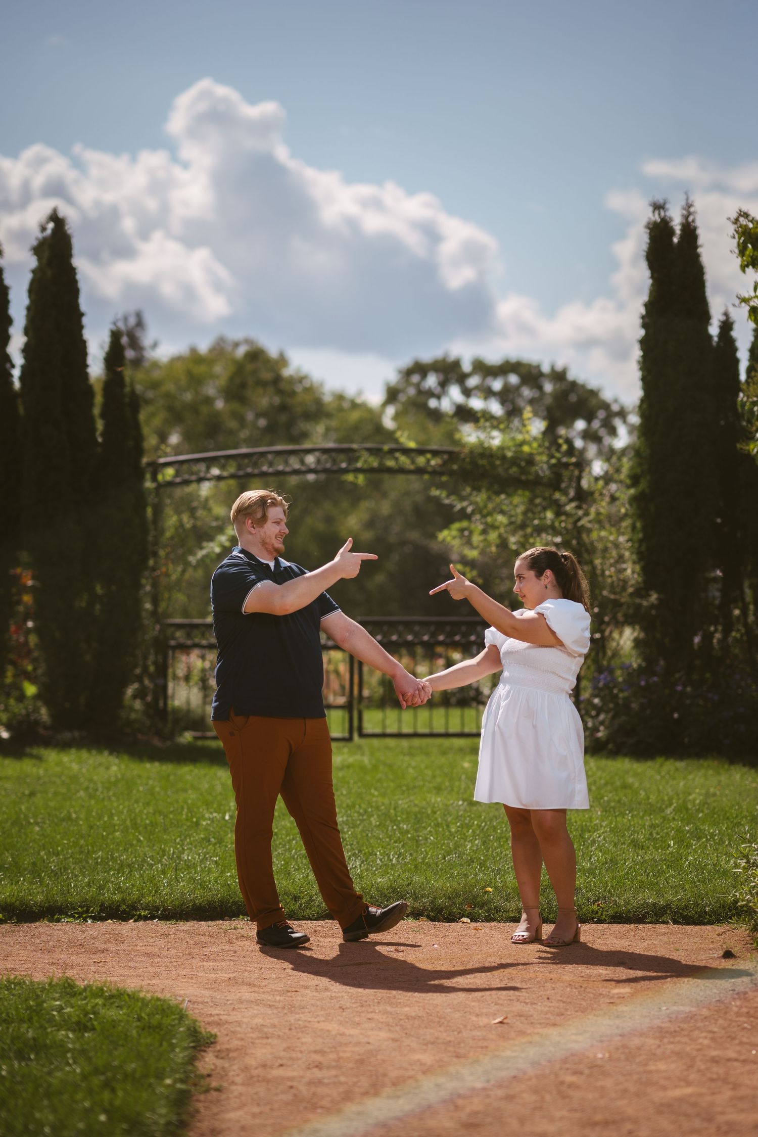 A couple's proposal moment captured in a series of photos on a garden path.