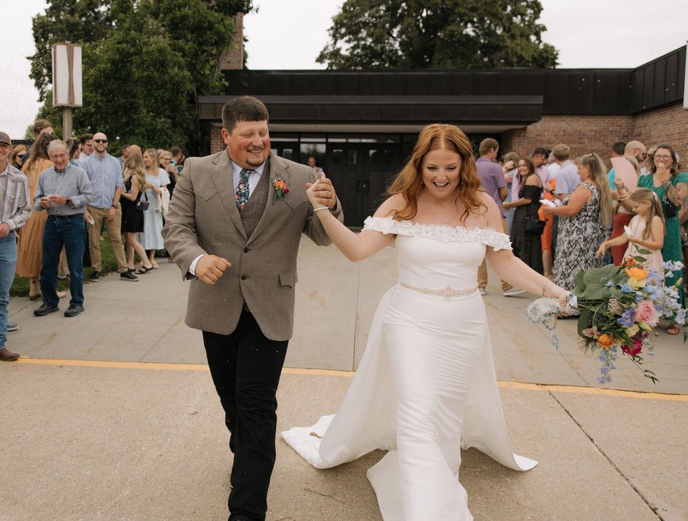 Wedding couple dances together on outdoor patio during summer celebration.