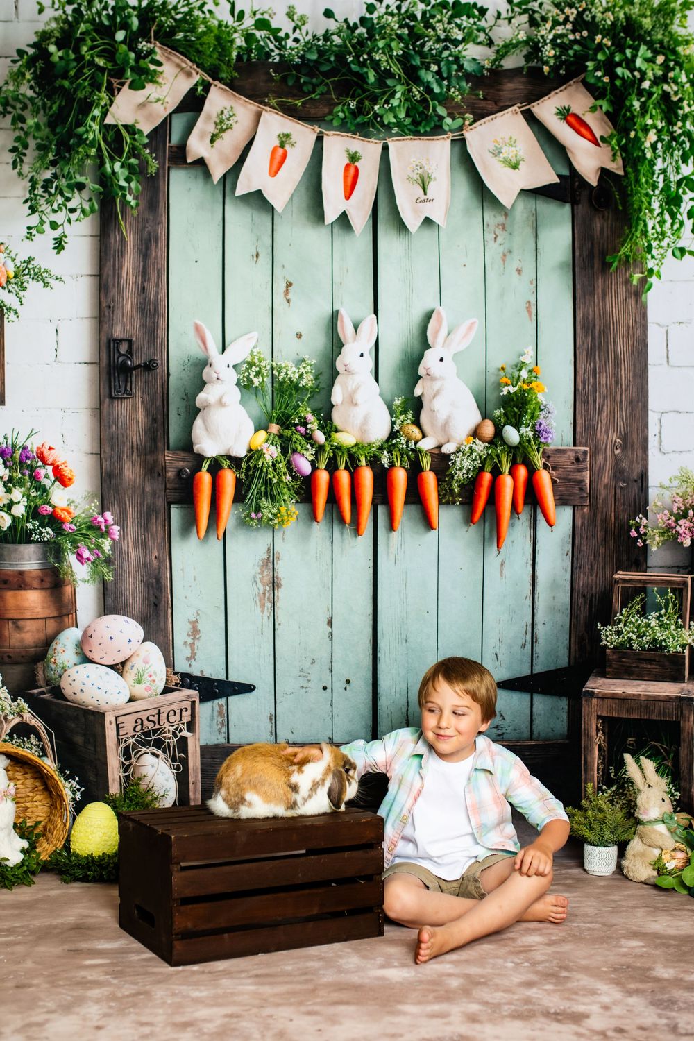 Easter photo setup with mint green door, white bunnies holding carrots, festive banner, and rustic spring decorations.