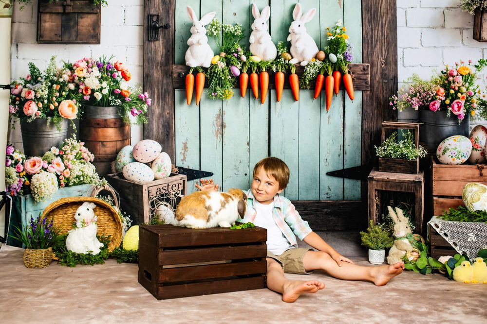 Easter spring setup with wooden crate, bunny decorations, carrots, and rustic farmhouse details against turquoise barn door.