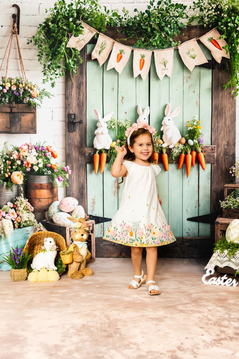 Easter photo setting with mint door, bunny decorations, carrot garland and spring floral arrangements.