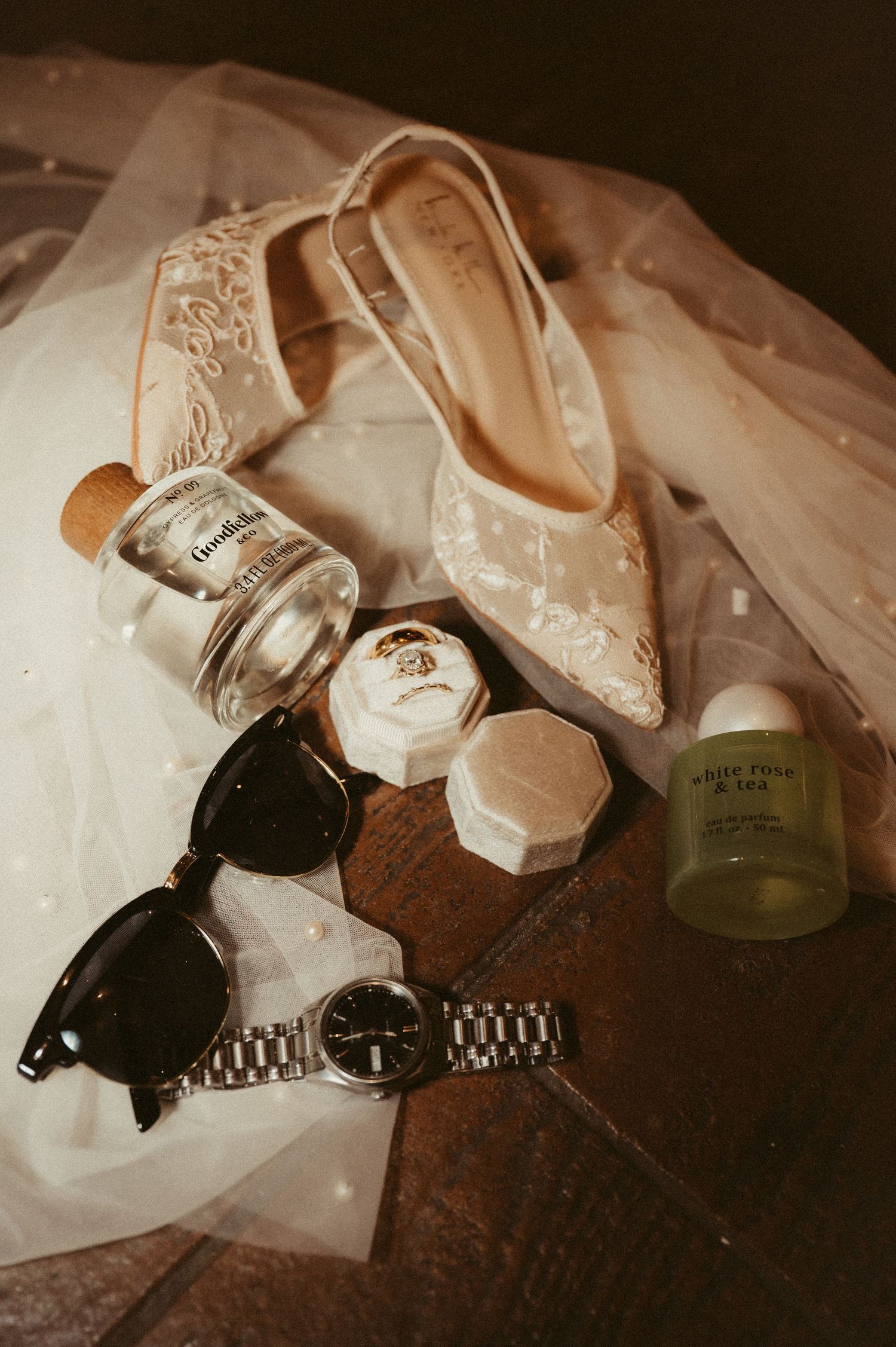 Indiana Wedding and Elopement Photographer // Wedding accessories including shoes, jewelry, and a watch arranged on a dark surface.