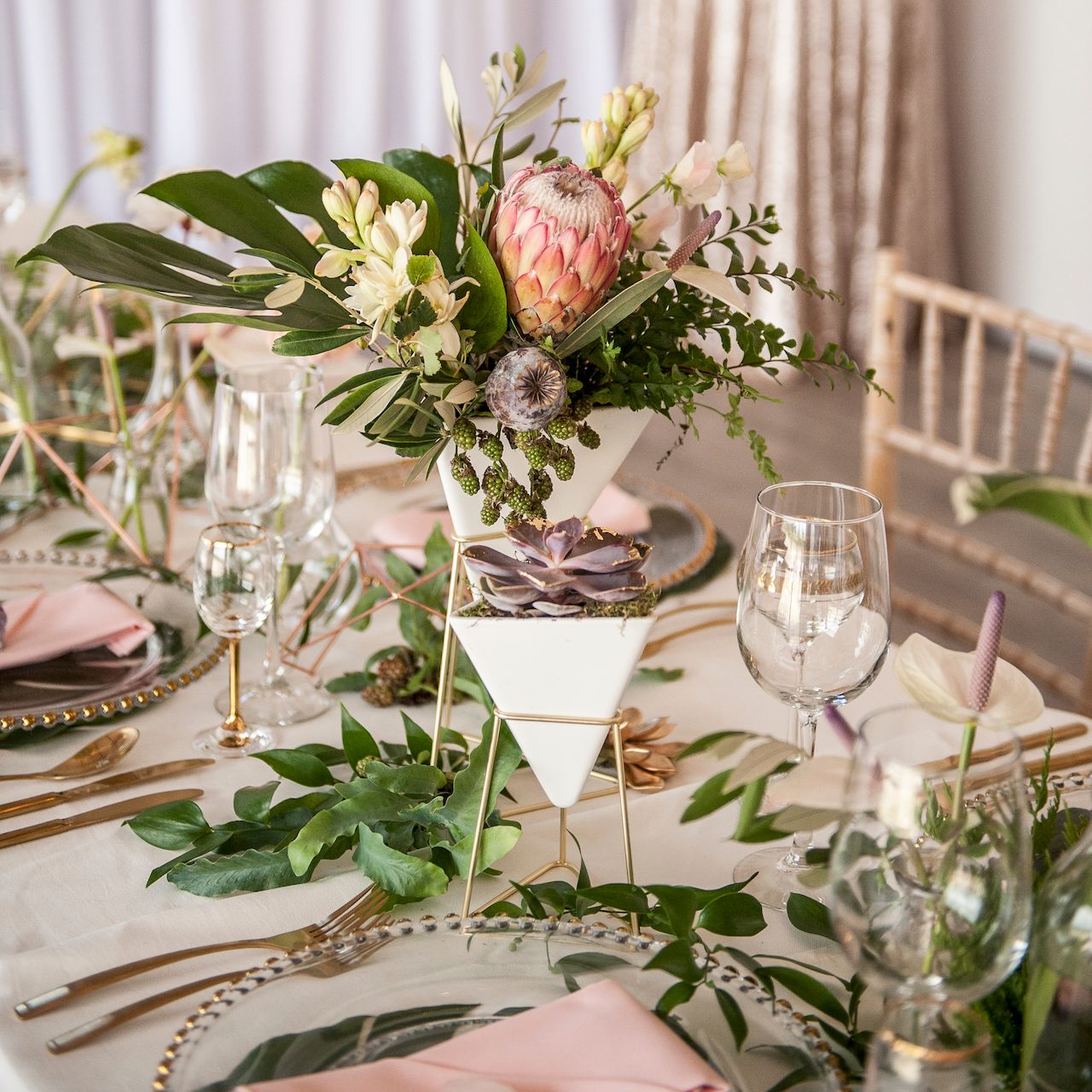 Tropical themed top table for a wedding in Oxfordshire, UK - Stratton Court Barn. Natural light reportage storytelling image