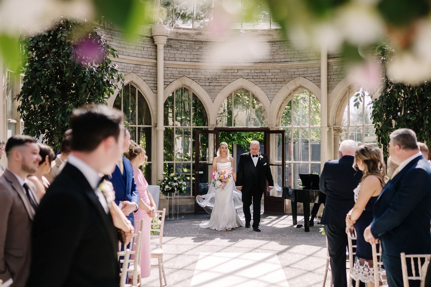 Bride walks down the aisle at Tortworth Court Orangery