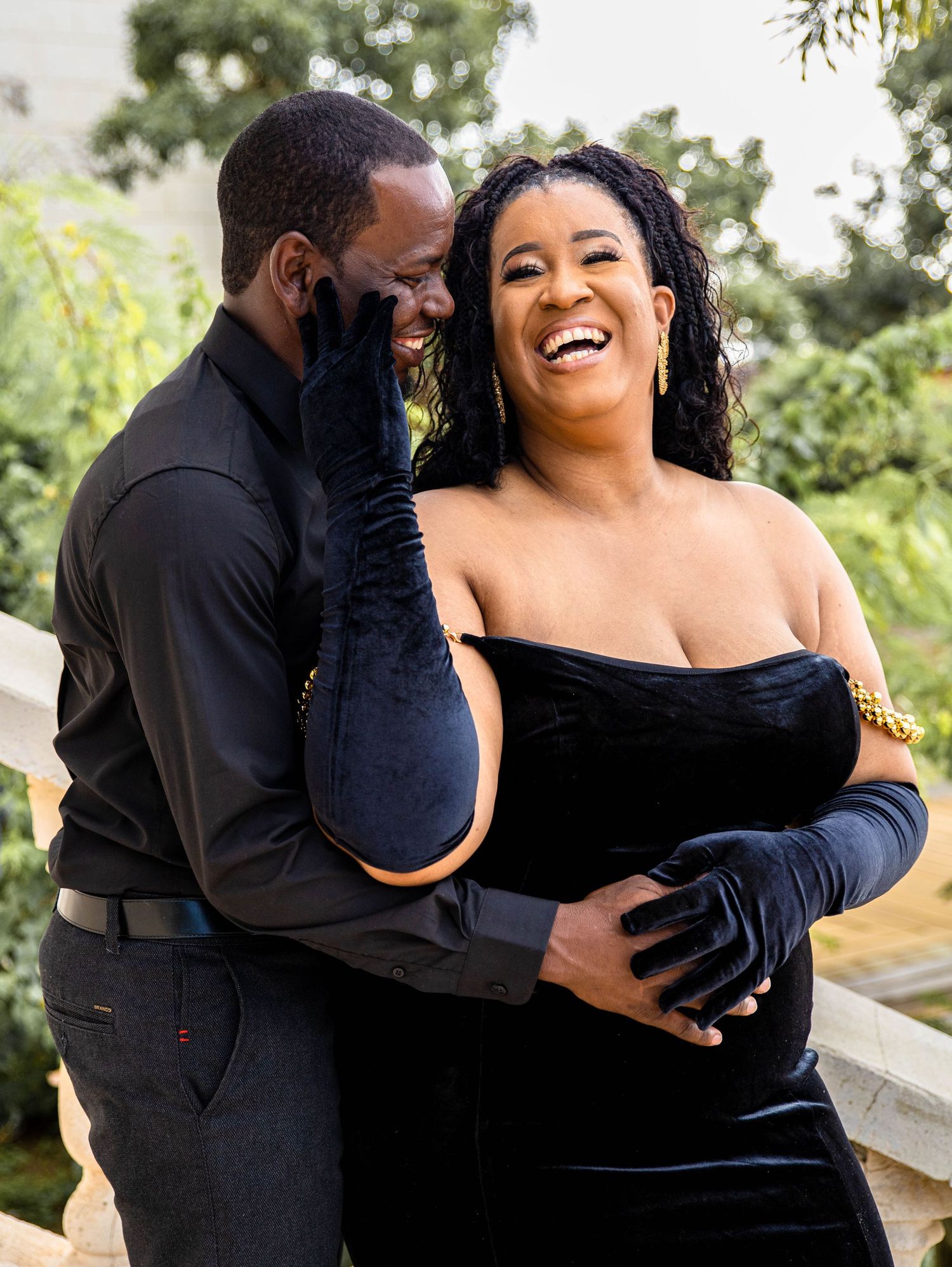Romantic engagement photo of a couple sharing a candid laugh together.