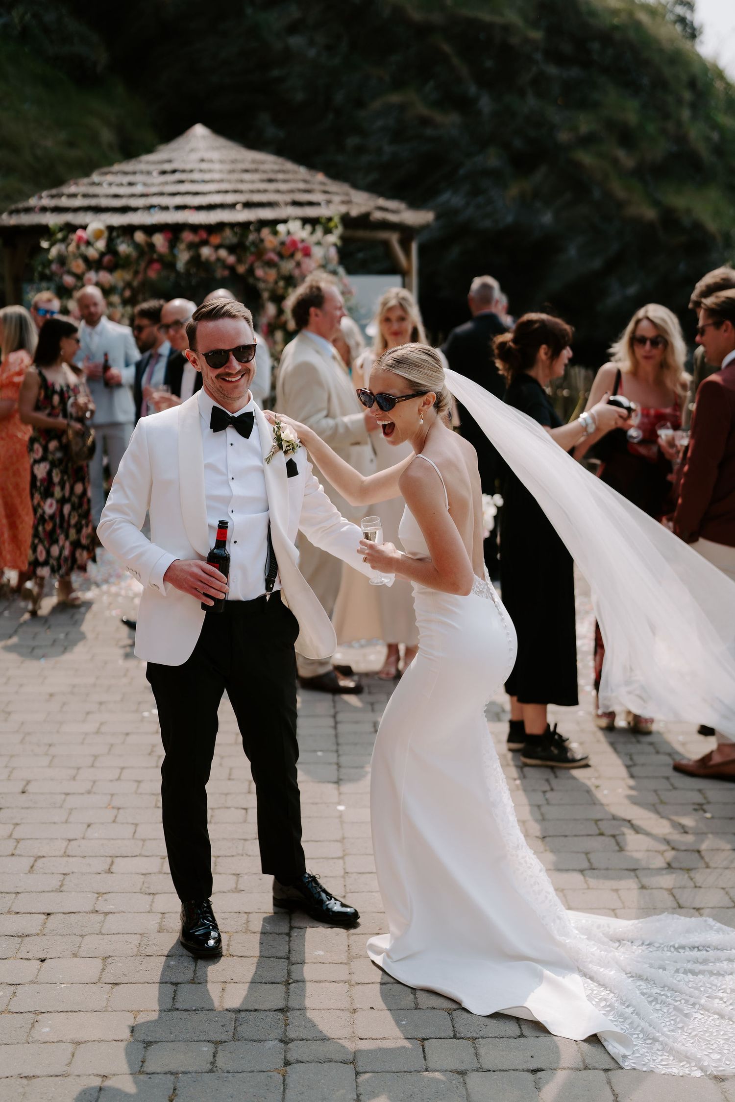 Bride and Groom celebrating drinks reception at Tunnels Beach wedding venue in north Devon