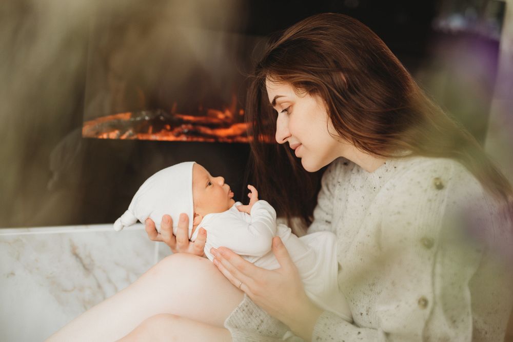 A tender moment of feeding and bonding with a newborn baby in a warm and cozy setting.