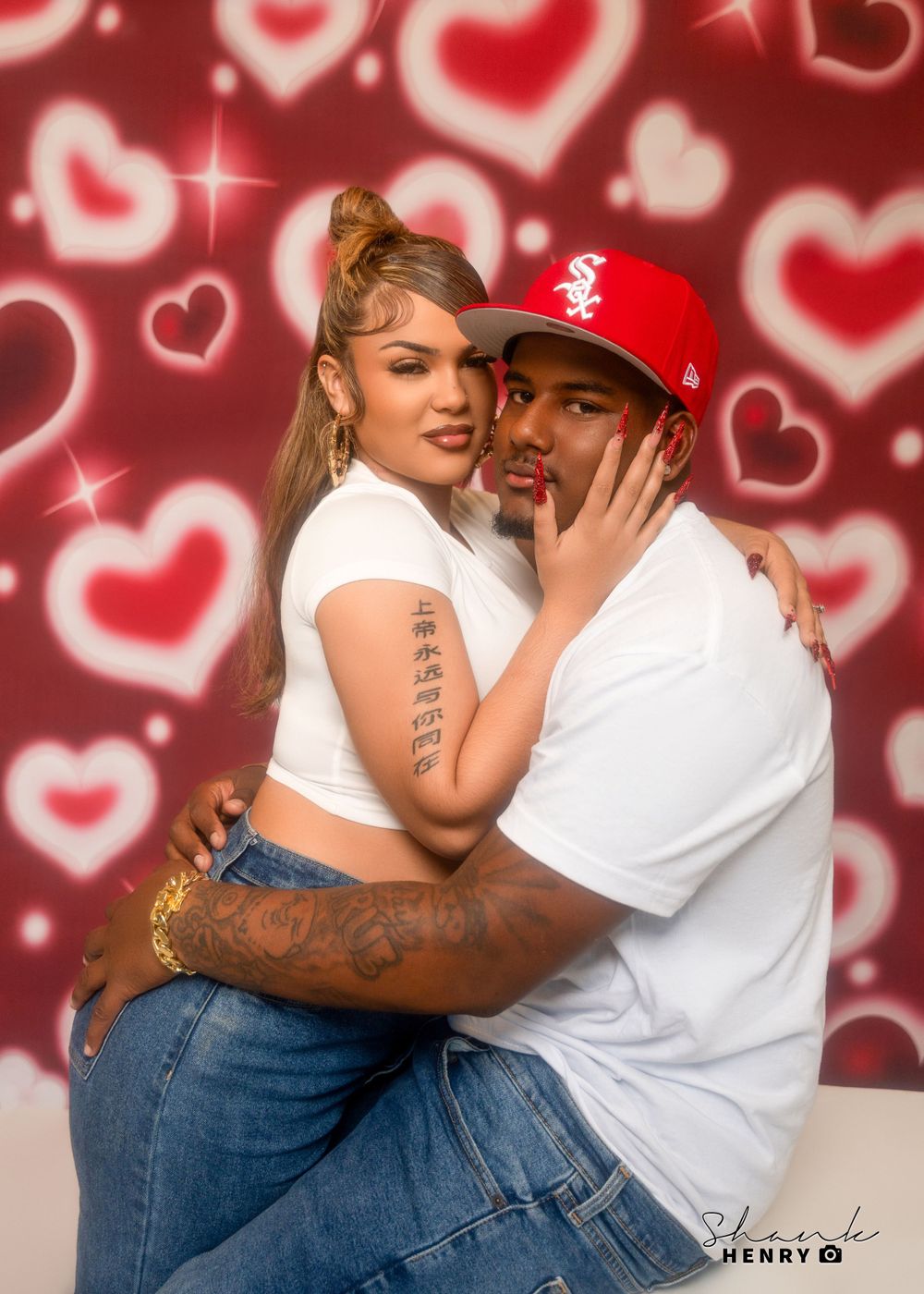 Romantic portrait of couple embracing against red background with heart pattern effects.