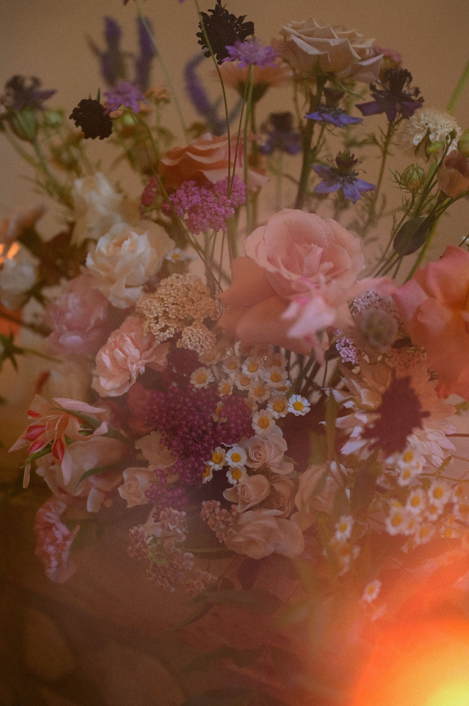 Delicate pink and purple floral arrangement with soft lighting and romantic ambiance.