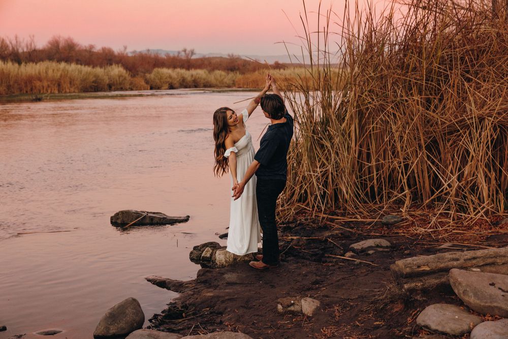 Playfully dancing along the Salt River with pink skies in the background.