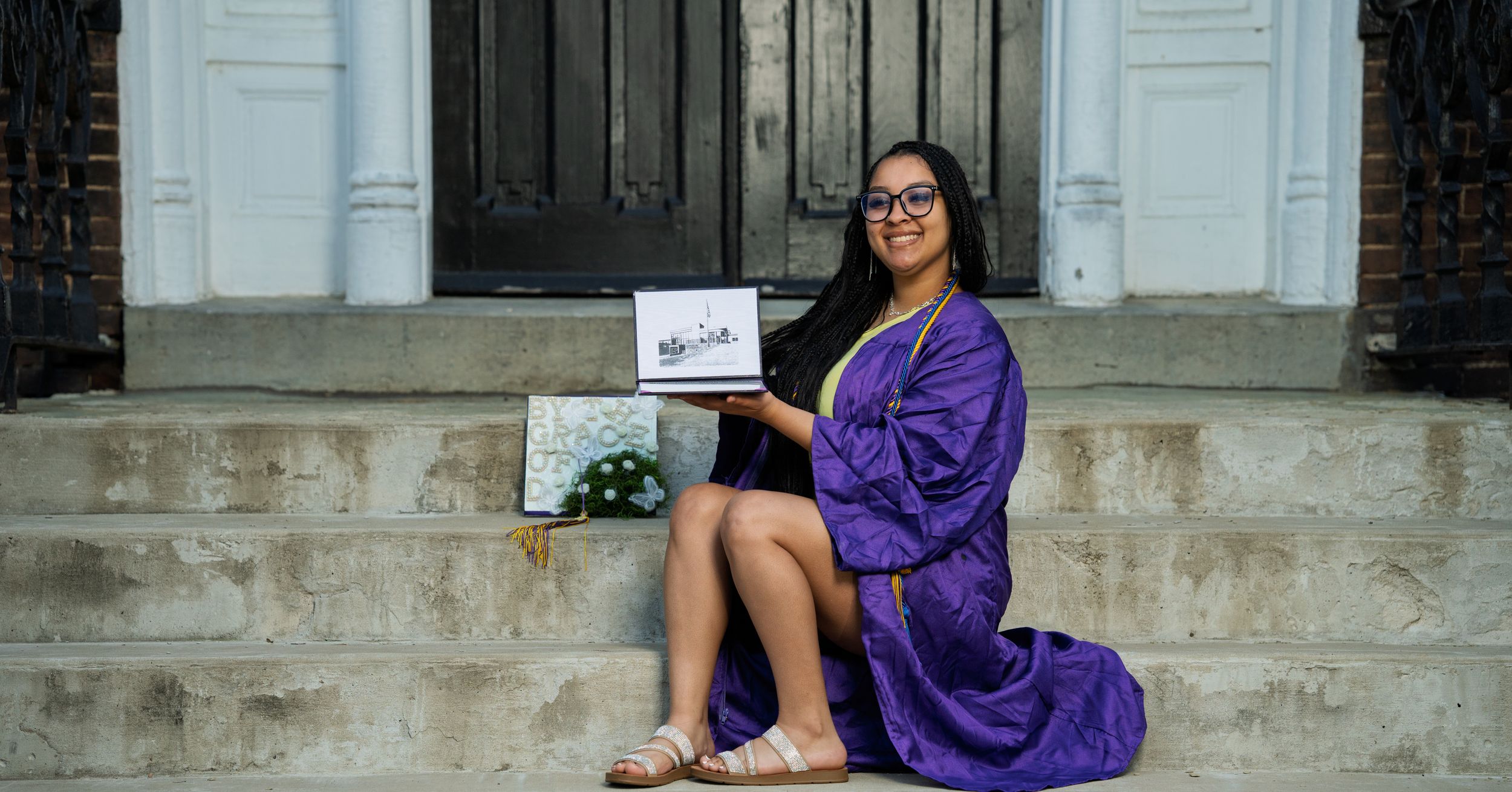 Graduation photo with diploma and cap and gown