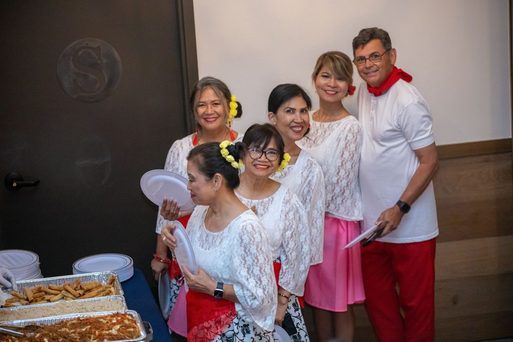 Group gathered at a community event wearing festive attire.