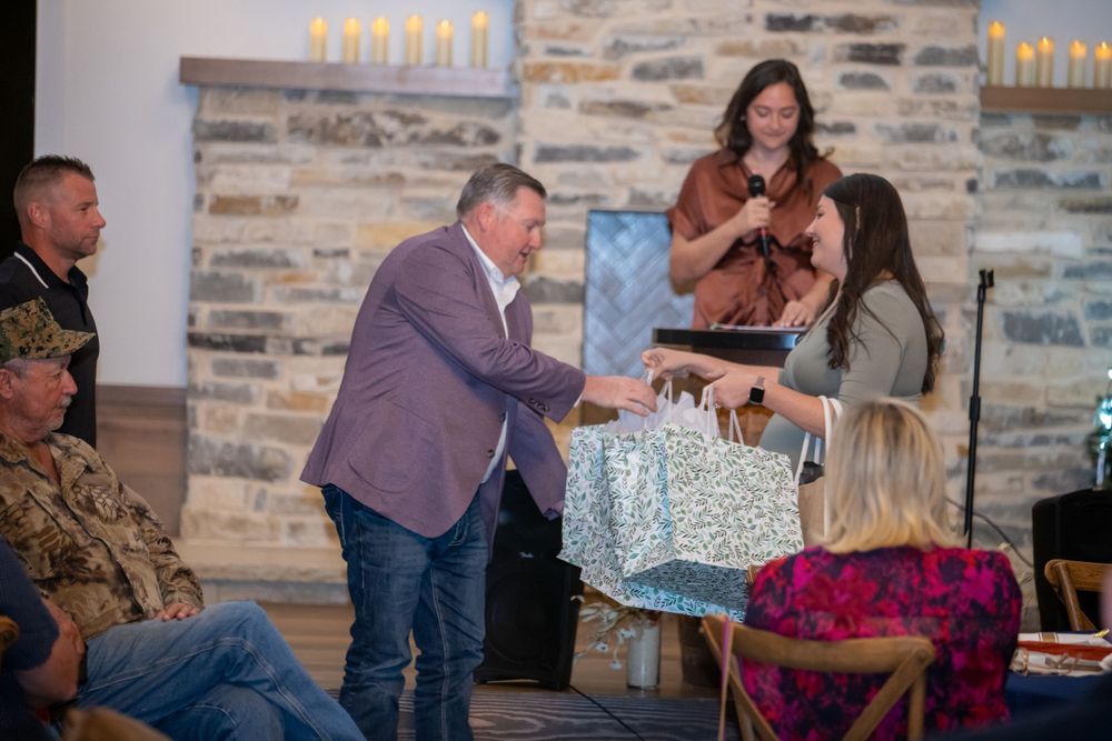 Guests gathered in a rustic venue with stone walls and lit candles for a special occasion.