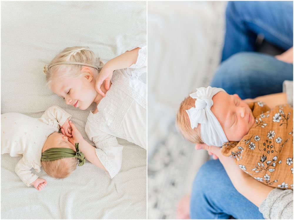 Sleeping baby in soft white bedding next to a sibling during a newborn photo shoot.