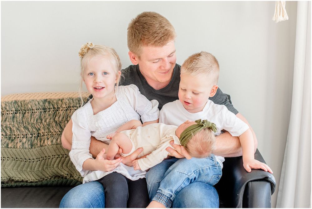 Heartwarming family moment captured on couch during indoor lifestyle session.