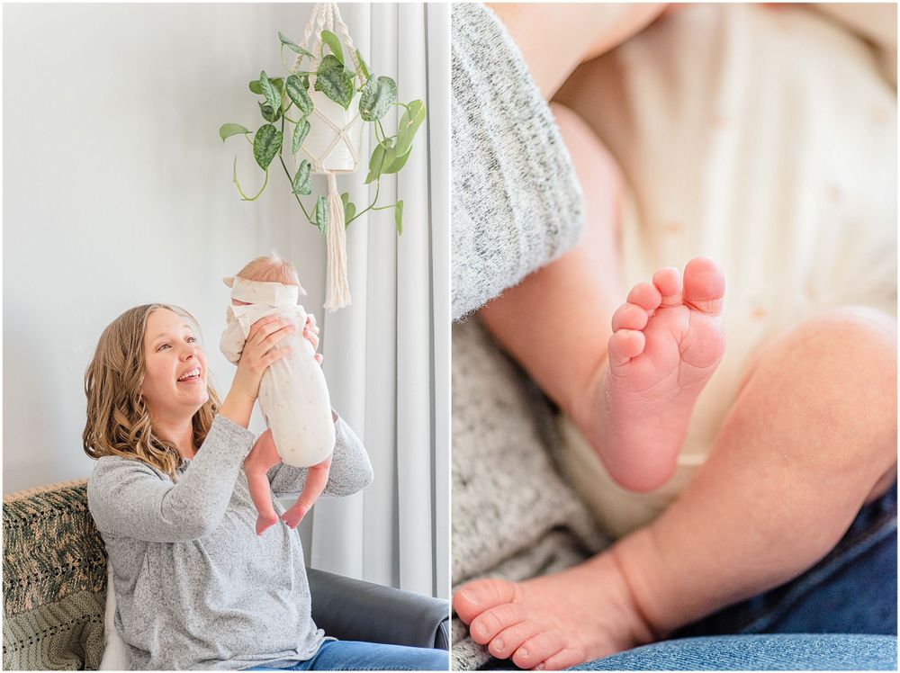 A tender moment with a baby captured in a bright indoor setting with hanging plants.